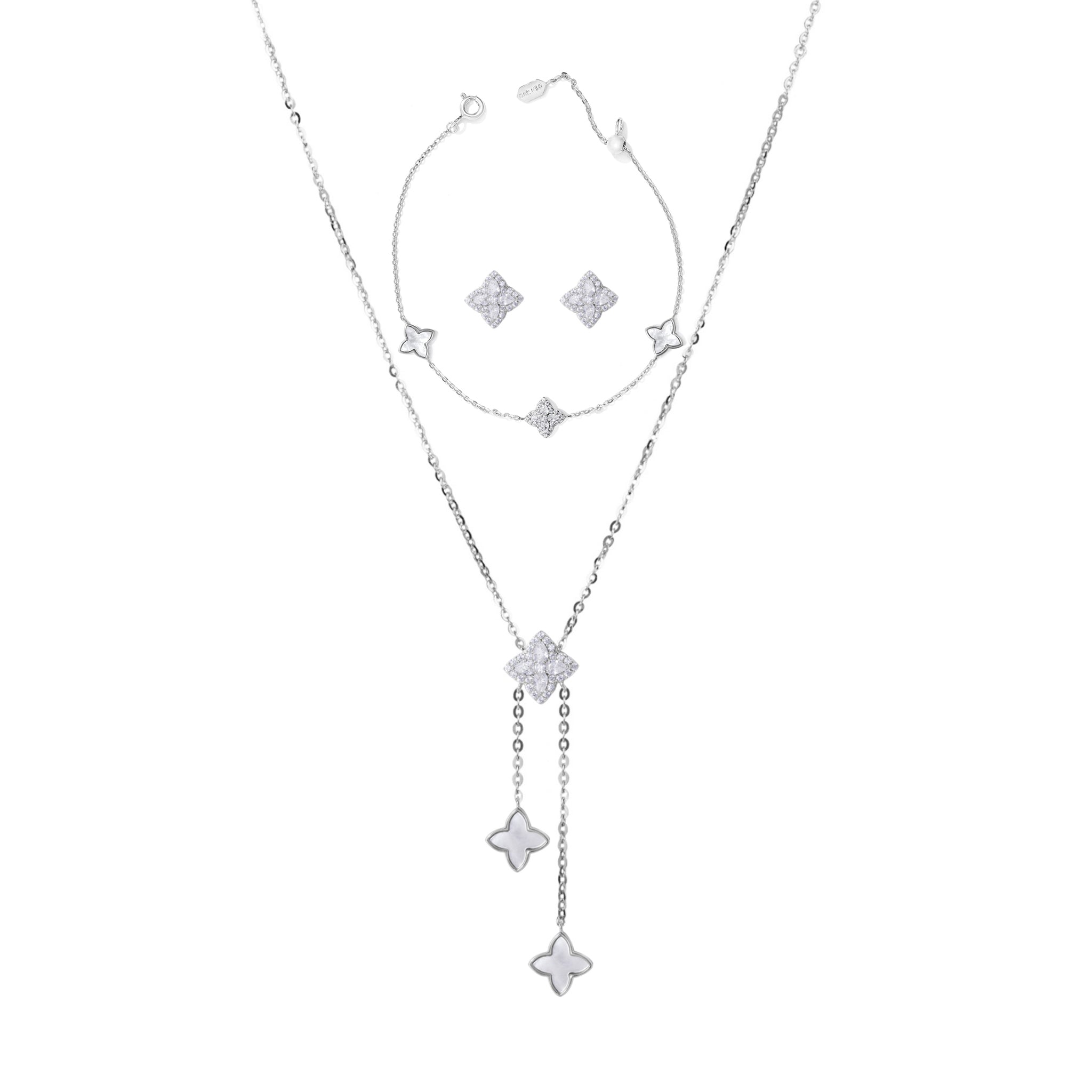 A sterling silver jewelry set including a necklace with a star-shaped pendant, a pair of earrings, and a bracelet, displayed against a white background.
