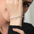 Pearl bracelet on a wrist with a neutral background