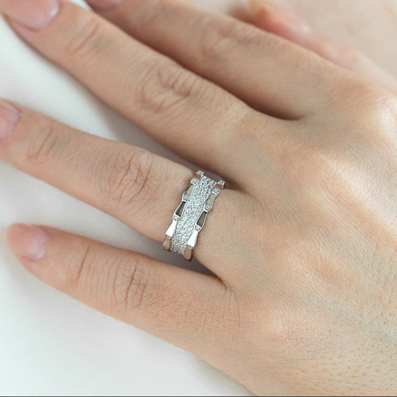 Silver ring on a person's finger against a white background