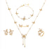 Gold butterfly-themed jewelry set including necklace, earrings, and ring on a white background