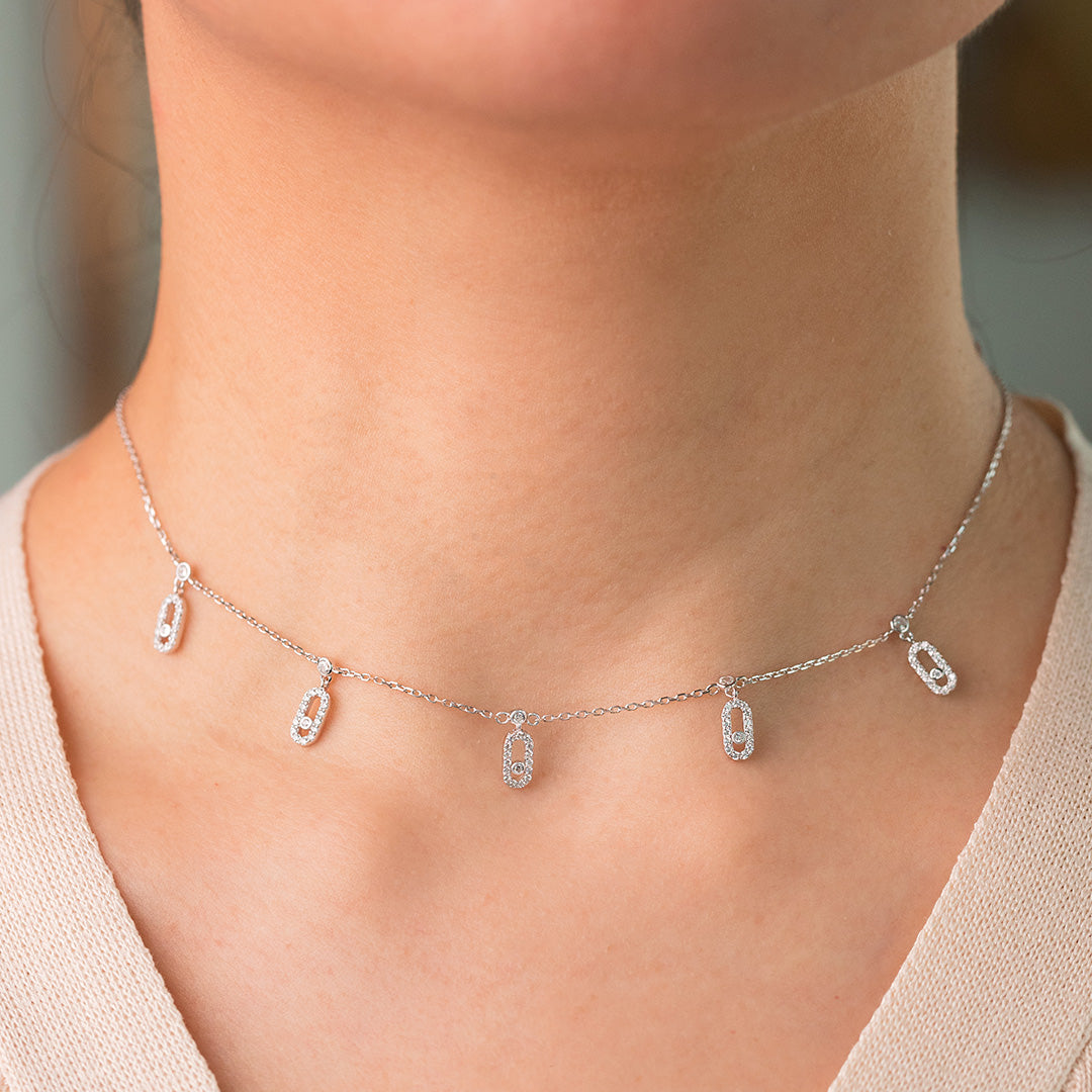a sterling silver 925 choker necklace with 18K gold plating and zircon stones.