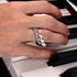 Hand with multiple rings on a piano keyboard