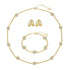Gold jewelry set with necklace, bracelet, and earrings on a white background