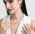 Woman wearing a diamond necklace and earrings on a white background